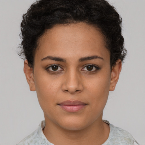 Joyful latino young-adult female with short  brown hair and brown eyes