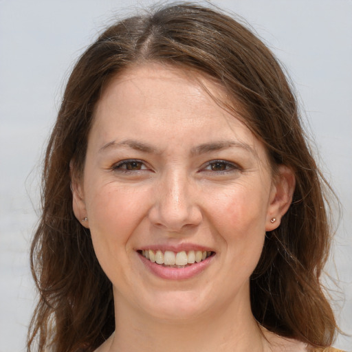 Joyful white young-adult female with long  brown hair and grey eyes