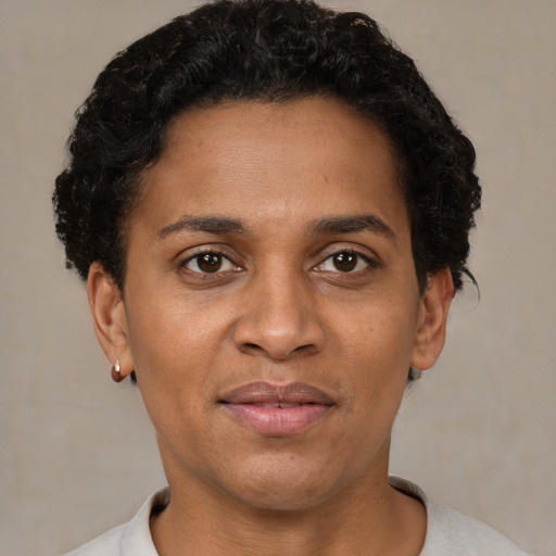 Joyful black adult female with short  brown hair and brown eyes
