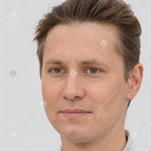 Joyful white adult male with short  brown hair and brown eyes