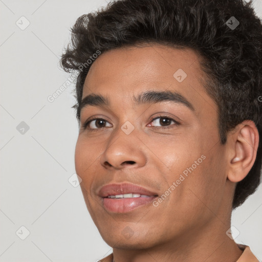 Joyful white young-adult male with short  black hair and brown eyes