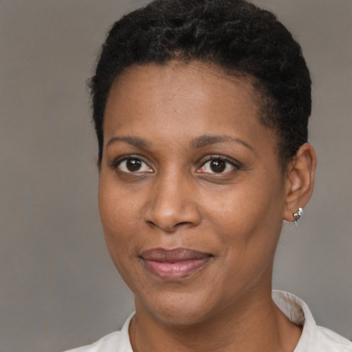 Joyful black young-adult female with short  black hair and brown eyes