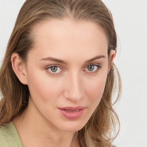 Joyful white young-adult female with long  brown hair and blue eyes