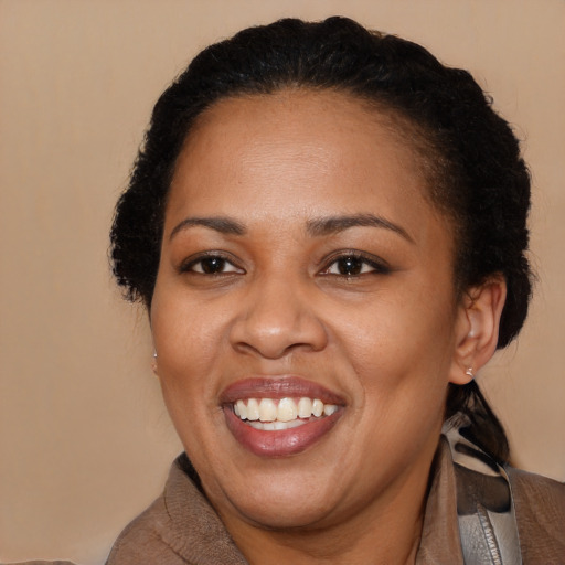 Joyful black adult female with short  brown hair and brown eyes