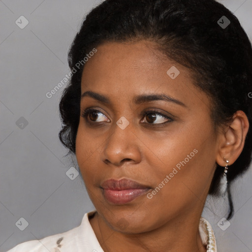 Joyful black young-adult female with medium  brown hair and brown eyes