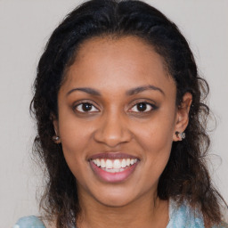 Joyful black young-adult female with medium  brown hair and brown eyes