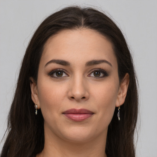 Joyful white young-adult female with long  brown hair and brown eyes