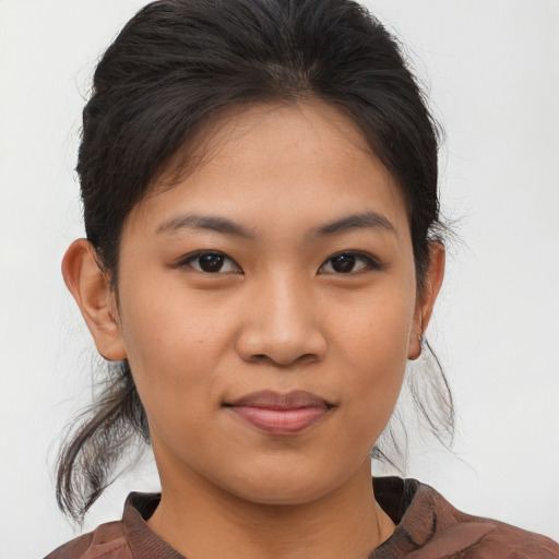 Joyful asian young-adult female with medium  brown hair and brown eyes