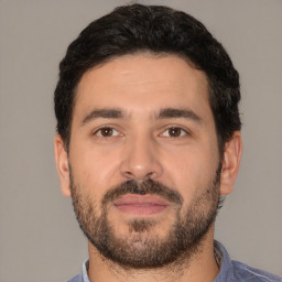 Neutral white young-adult male with short  black hair and brown eyes
