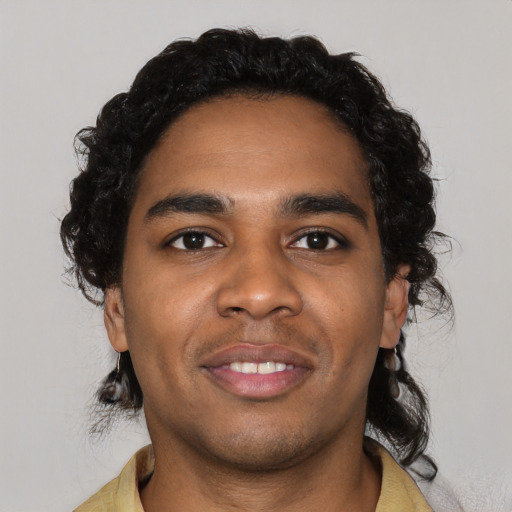 Joyful black young-adult male with short  black hair and brown eyes