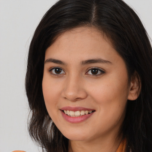 Joyful white young-adult female with long  brown hair and brown eyes