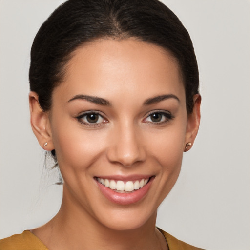 Joyful white young-adult female with long  brown hair and brown eyes