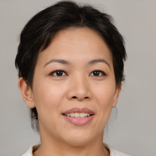 Joyful asian young-adult female with medium  brown hair and brown eyes