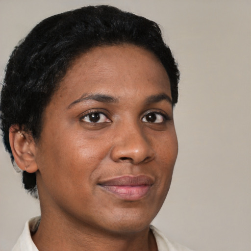 Joyful black young-adult female with short  brown hair and brown eyes