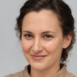 Joyful white adult female with medium  brown hair and brown eyes