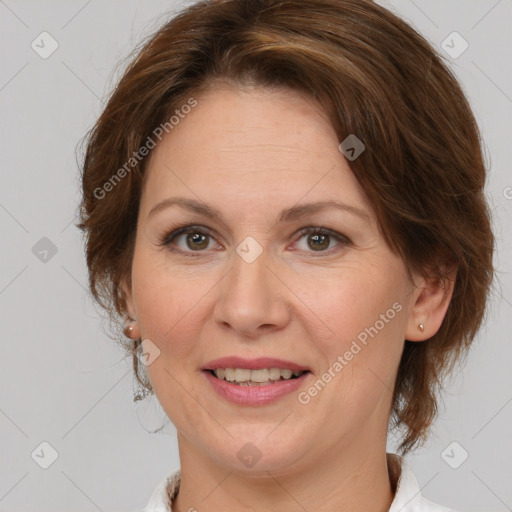 Joyful white adult female with medium  brown hair and brown eyes