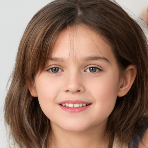 Joyful white child female with medium  brown hair and brown eyes