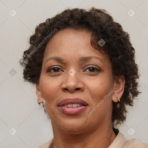 Joyful black adult female with short  brown hair and brown eyes