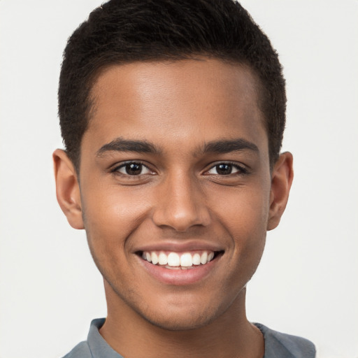 Joyful black young-adult male with short  brown hair and brown eyes