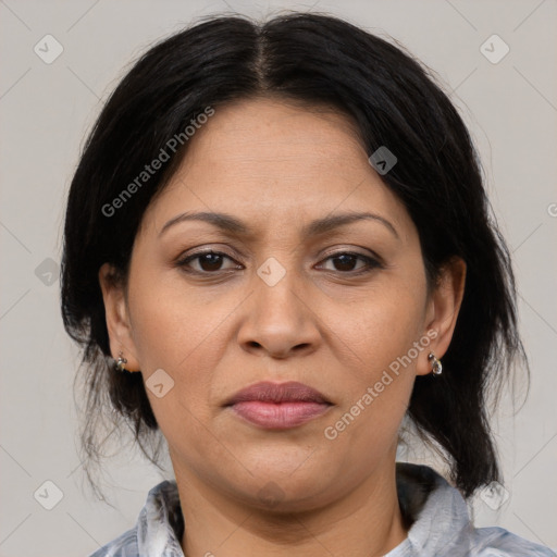 Joyful latino adult female with medium  brown hair and brown eyes