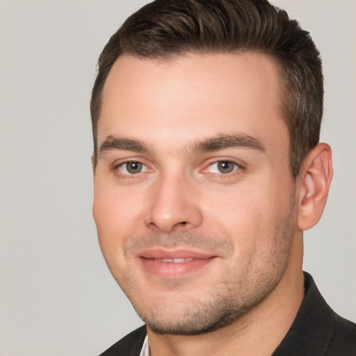 Joyful white young-adult male with short  brown hair and brown eyes