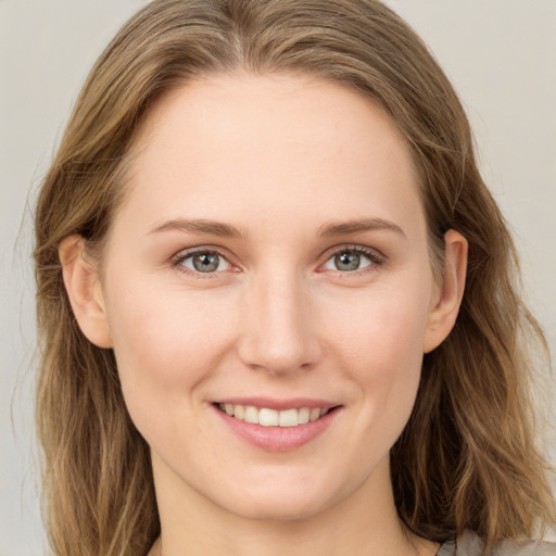 Joyful white young-adult female with long  brown hair and grey eyes