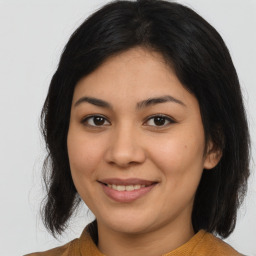 Joyful latino young-adult female with medium  brown hair and brown eyes