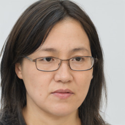 Joyful white adult female with long  brown hair and brown eyes