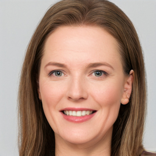 Joyful white young-adult female with long  brown hair and grey eyes