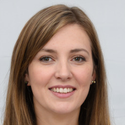 Joyful white young-adult female with long  brown hair and green eyes