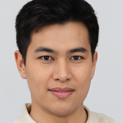 Joyful asian young-adult male with short  brown hair and brown eyes