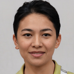 Joyful asian young-adult female with short  brown hair and brown eyes