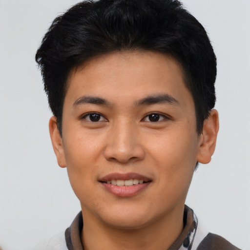 Joyful asian young-adult male with short  black hair and brown eyes