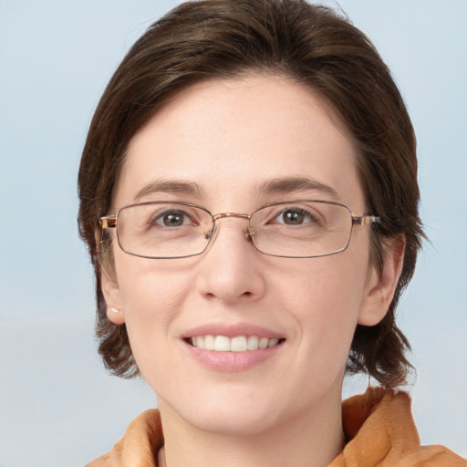 Joyful white young-adult female with medium  brown hair and blue eyes