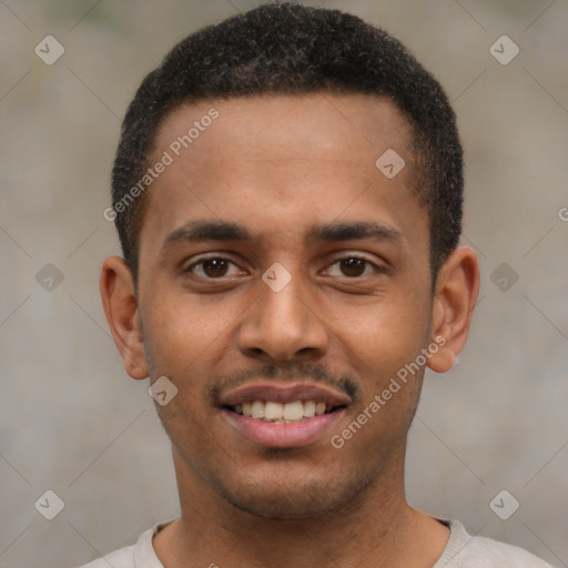 Joyful black young-adult male with short  brown hair and brown eyes