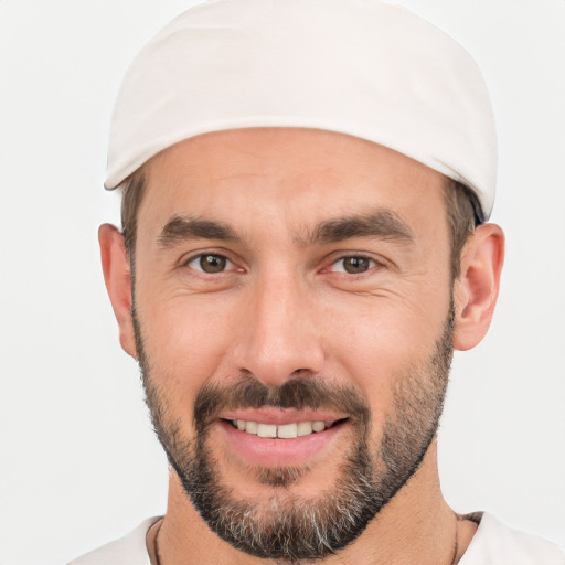 Joyful white young-adult male with short  black hair and brown eyes