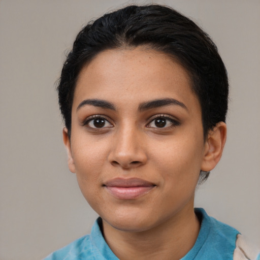 Joyful latino young-adult female with short  black hair and brown eyes