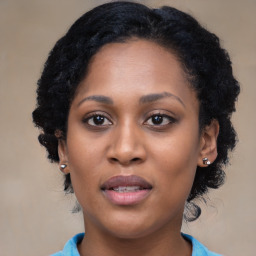 Joyful black young-adult female with medium  black hair and brown eyes