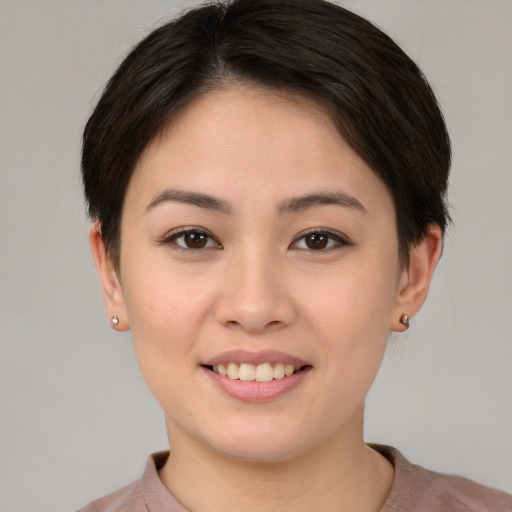 Joyful white young-adult female with short  brown hair and brown eyes