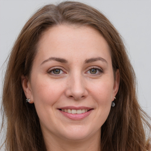 Joyful white young-adult female with long  brown hair and grey eyes