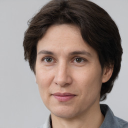 Joyful white adult female with medium  brown hair and brown eyes