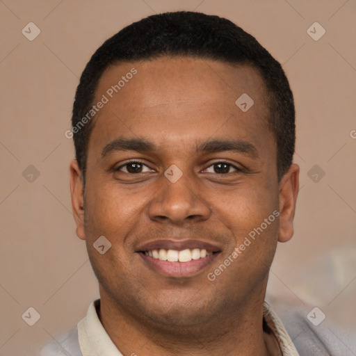 Joyful latino young-adult male with short  black hair and brown eyes