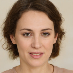 Joyful white young-adult female with medium  brown hair and green eyes