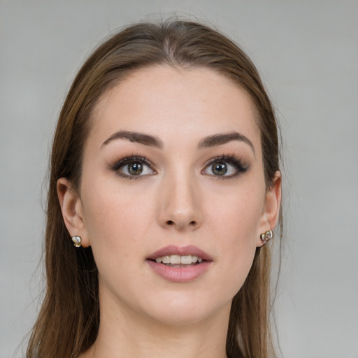 Joyful white young-adult female with long  brown hair and grey eyes