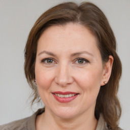 Joyful white adult female with medium  brown hair and grey eyes