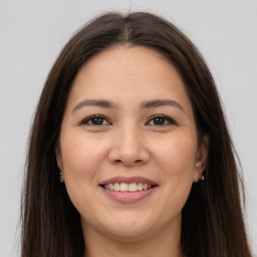 Joyful white young-adult female with long  brown hair and brown eyes