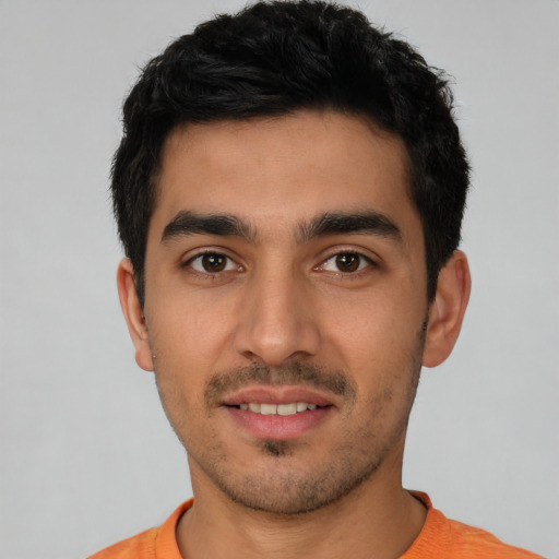 Joyful white young-adult male with short  black hair and brown eyes