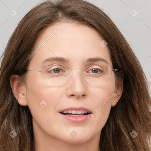 Joyful white adult female with long  brown hair and blue eyes