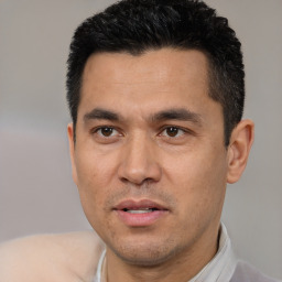Joyful white adult male with short  black hair and brown eyes