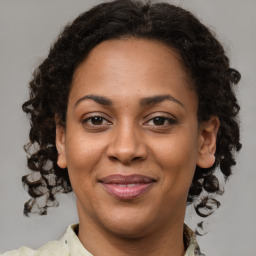 Joyful black adult female with medium  brown hair and brown eyes